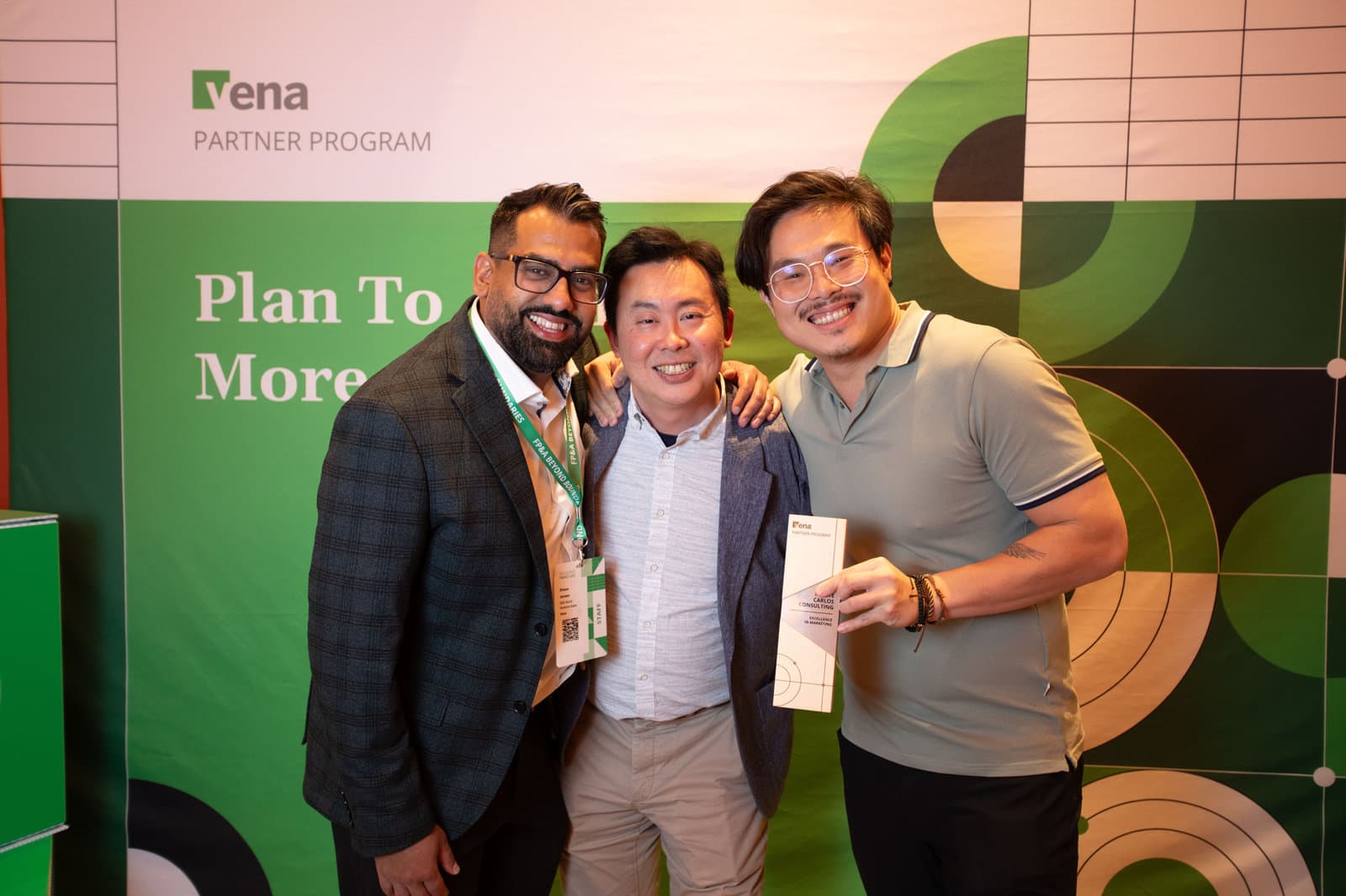 Three people at a Vena Partner Program event, one holding MCC's Excellence in Marketing award